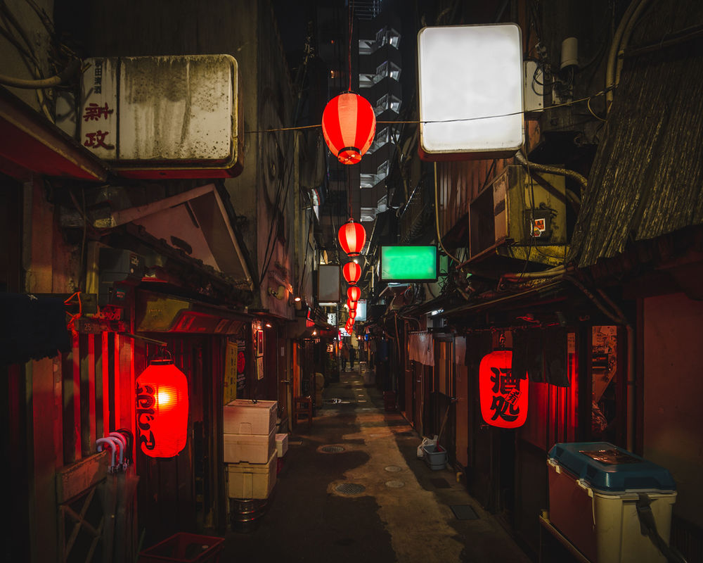 Red lanterns in a narrow drinking alley at night